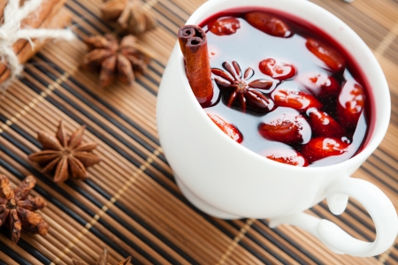 18500068 - mulled wine in a white cup and star anise, closeup